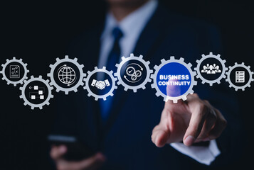 Business continuity concept. Businessman interact with gear featuring business continuity icons. strategies for maintaining operations during disruptions. minimizing financial losses, Risk management,