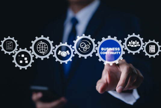 Business continuity concept. Businessman interact with gear featuring business continuity icons. strategies for maintaining operations during disruptions. minimizing financial losses, Risk management,
