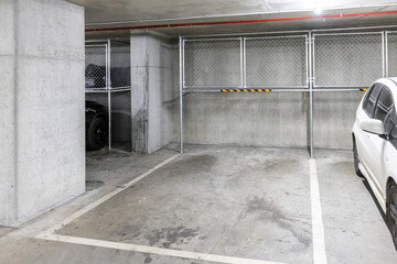 Over bonnet storage concept in Melbourne, Australia apartment underground car park with metal cages...