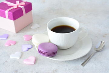 a cup of coffee and a box of chocolates and some pink and blue silk hearts 