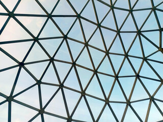 The roof structure of the modern glass dome architecture and blue sky.