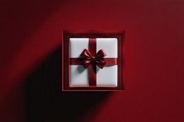 Open white gift package or bird's-eye perspective of white gift tied with crimson ribbon on dark red surface with shadow, simple conceptual 3d image