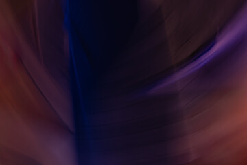 Fototapeta premium An abstract blur of dark and light shades, with swirling purples, blues, and hints of red in the composition.