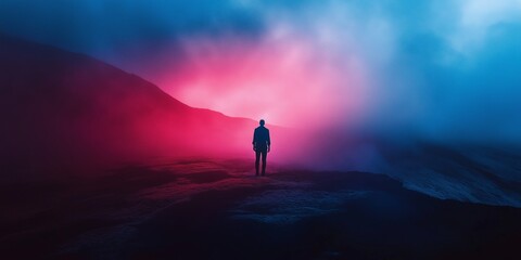 Fototapeta premium A lone figure stands against a surreal sky with pink and blue hues, creating an ethereal and contemplative scene.
