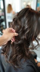 A customer at a casual salon gets a braided or curly hairstyle by a hairdresser. The salon has a welcoming vibe, making it popular.