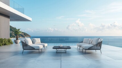 Fototapeta premium A modern outdoor seating arrangement with cushioned chairs and a coffee table on a sleek patio overlooking the ocean.