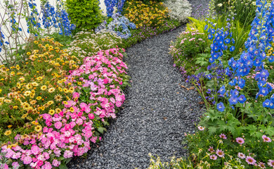 colorful flowers with rock path leading through a flower garden