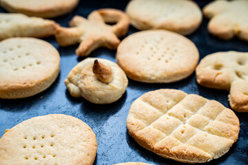 Homemade cookies of cheerful shapes made by a child on the protvina. A family hobby.