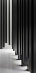Obraz premium A striking abstract view of modern architecture featuring geometric black columns in a minimalist interior setting.