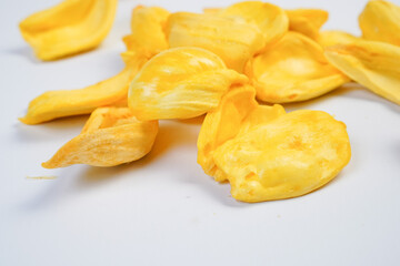 A pile of yellow nuts on a white background