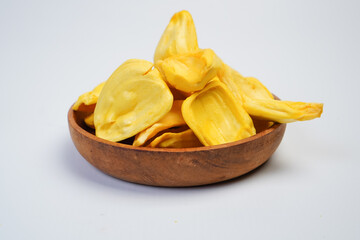 A bowl of yellow chips sits on a white background