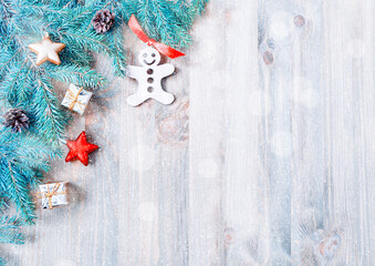 New Year and Christmas background. Christmas toys, blue fir tree branches on the wooden background. New Year and Christmas still life, free space for text