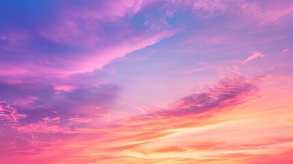 Obraz premium Colorful sky at sunset with vivid pink, purple, and orange clouds. Concept of evening, serenity, and nature's beauty.