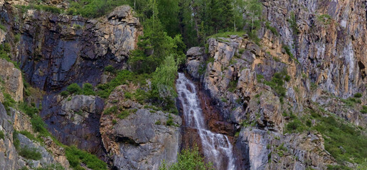 Obraz premium landscape with waterfall between dark rocks
