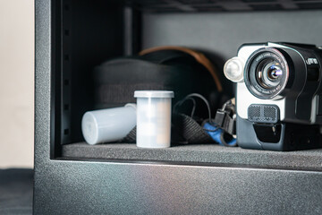 Vintage Camcorder and Film Canister in Metal Cabinet