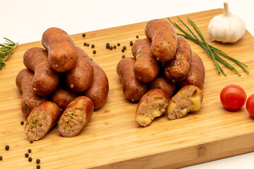 A Selection of Delicious Sausages Presented on a Wooden Board Alongside Fresh Ingredients