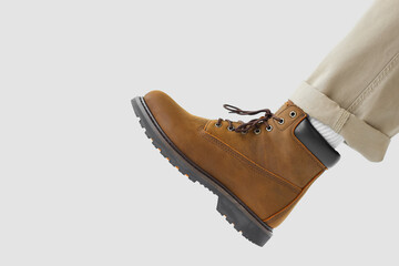 Man in yellow winter boots on white background
