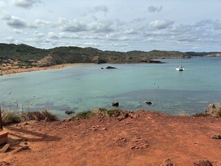 view of the sea from a red sand beach