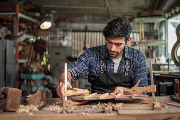 Luthier creating a guitar, clamps on the body of a guitar under construction improving glue adhesion