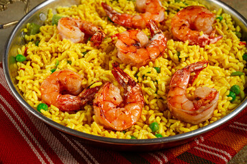 rice with saffron and shrimp, in a frying pan, paella with shrimp, top view, homemade, no people,
