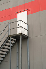 Metal fire escape stairs leading to door in building wall