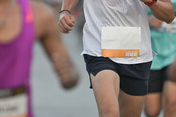 Male white runner shirt running marathon in the race run.Fitness and sport man running in outdoor...