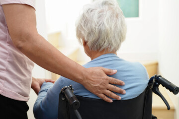 Asian senior woman on wheelchair with caregiver help support walking down the stairs prevent...