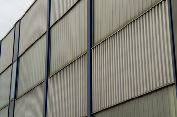 Modern building facade showing metal panels and glass windows