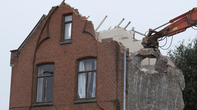 Demolition of a historic brick building in a small town captures the transformation of urban space