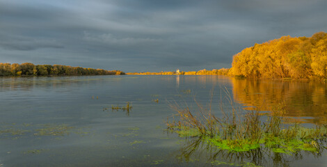 A body of water with a cloudy sky in the background