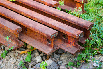 Close-up of a rusty piece of a pile of railroad tracks