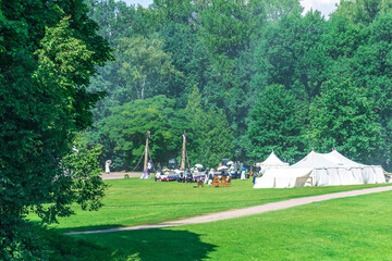 A group of tents are set up in a grassy field