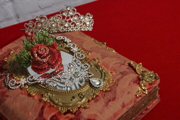 Elegant vintage jewelry on ornate book © Wirestock