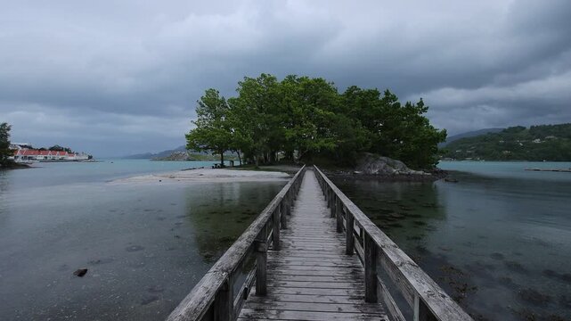 Picturesque jetty to a small island at the coastal town of Skanevik in Norway.