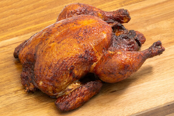 Hot Smoked Roasted Whole Chicken Served on a Rustic Wooden Cutting Board