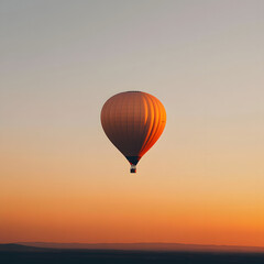 Obraz premium Hot Air Balloon Soaring at Sunset Over Landscape