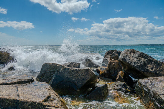 waves crashing on rocks - Powered by Adobe