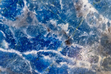 Blurred blue crystal background close up. Reminiscent of sea waves. Natural minerals. Background, backdrop, wallpaper.