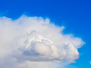 Fluffy white clouds drift across a bright blue sky in Sweden, showcasing the serene beauty of nature on a clear day