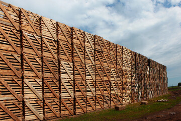 Rows of wooden crates, crates and pallets for storing and transporting fruits and vegetables in the warehouse. Production warehouse on territory of agro-industrial complex.