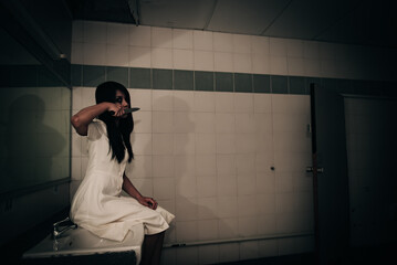 Portrait of asian woman make up ghost face with blood,Horror scene,Scary background,Halloween...