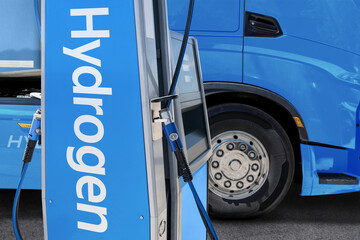 A hydrogen fuel cell semi truck with H2 gas cylinder onboard next to filling station. Eco-friendly...