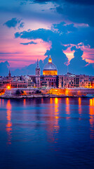 Fototapeta premium Valletta Skyline Illuminated by Sunset Glow, Reflections on Coastal Water, Historic Maltese Architecture, Dramatic Sky, Romantic Evening in Malta
