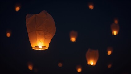 Golden paper lanterns illuminate the night sky casting a serene glow