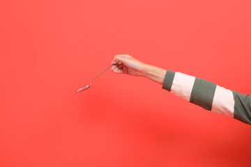 Hands holding spoon