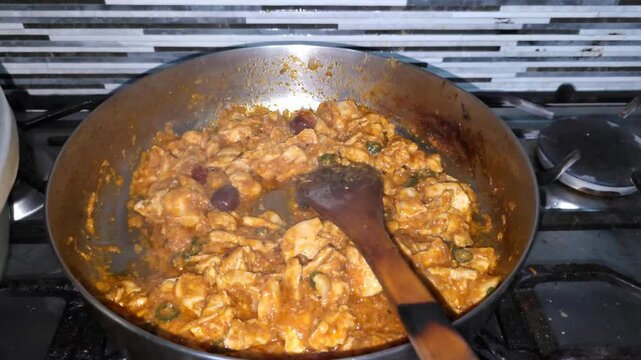 Cooking boneless chicken handi in a pan. Typical Pakistani dish. 