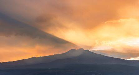 beautiful panorama of volcano mountain during evening synset with twilight clouds and shadows above majectic mountain and amazing cloudy sunset sky on background