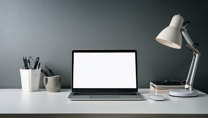 Laptop with blank screen and desk lamp on white table in grey room. 3D Rendering
