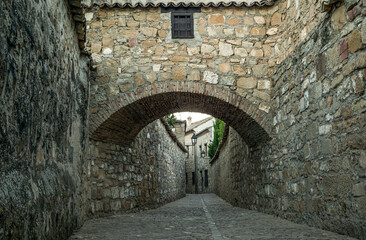 Alley in the old town of Baeza in Jaén, Andalusia, Spain, a World Heritage city, with an arch crossing from side to side an alley