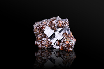 Fototapeta premium Spessartine garnet on Galena. Specimen from North Mine, broken hill, australia. photography isolated on black background. macro detail close-up mineral crystal unpolished semi-precious gemstone. 